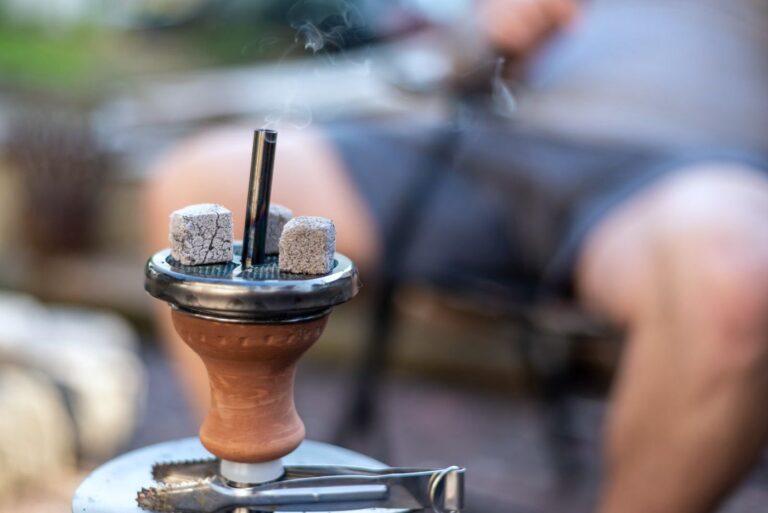 A lit waterpipe (shisha) with coals on top