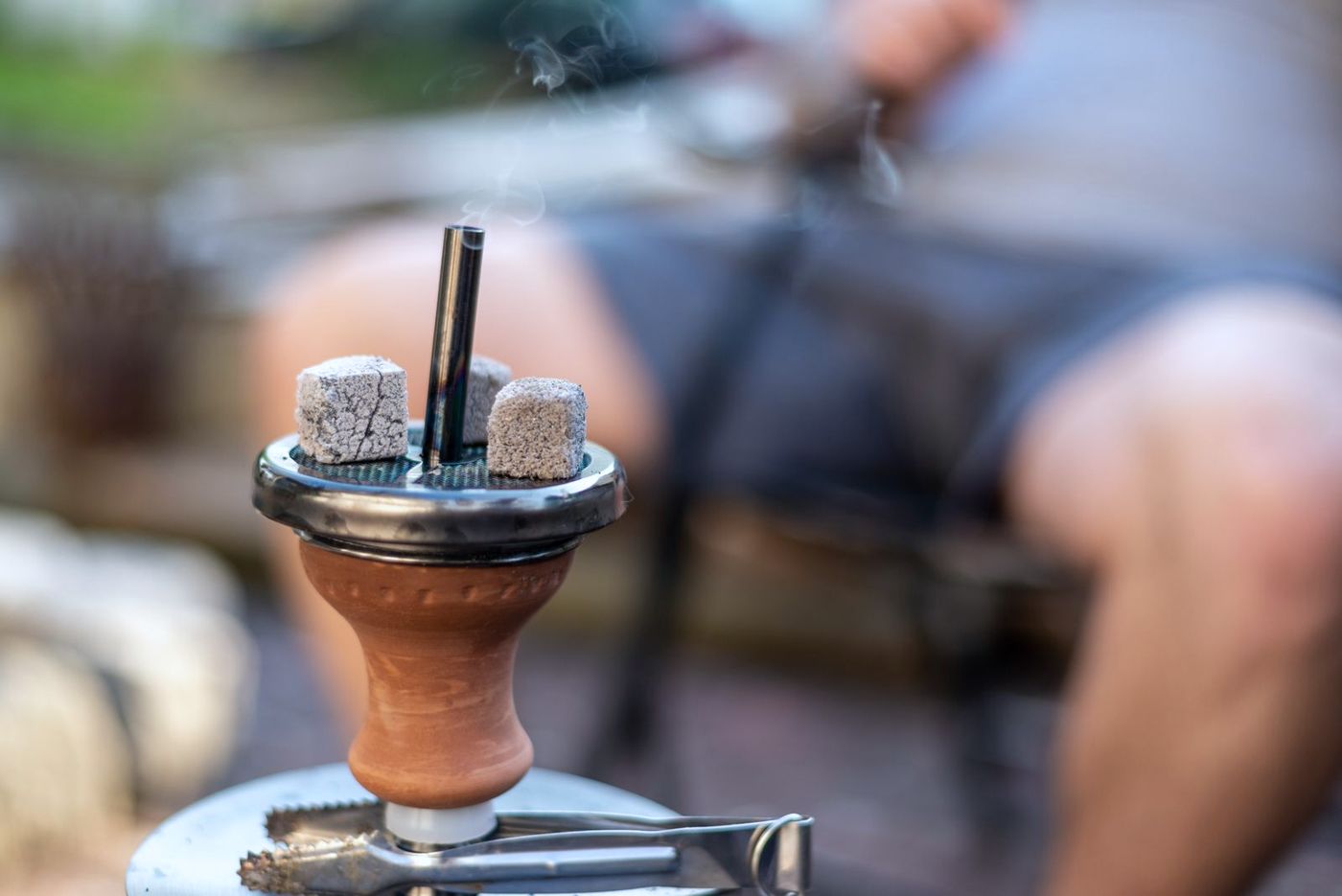A lit waterpipe (shisha) with coals on top