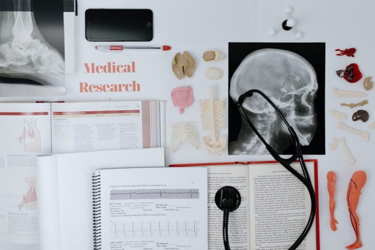 Medical research papers, books and X-rays on a desk